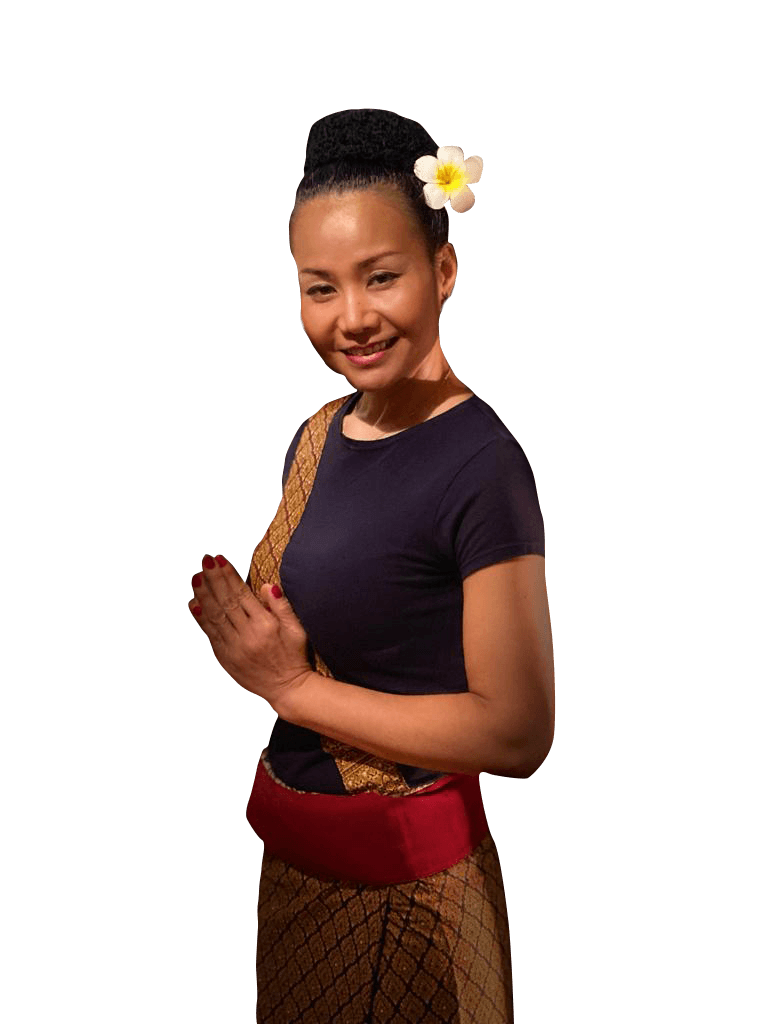Yom in traditionele Thaise kleding, met een bloem in het haar en de handen gevouwen tot een wai.